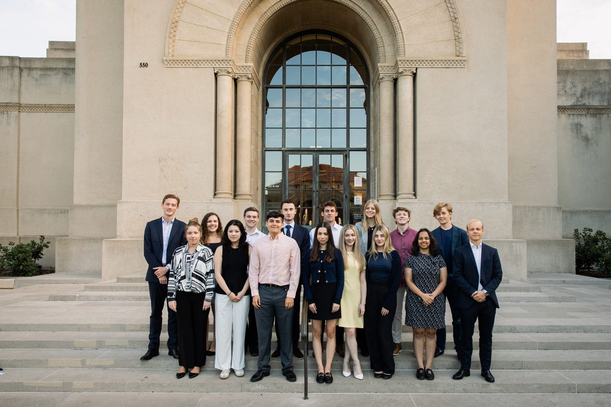 A group of participants in the Hoover Institution Summer Policy Boot Camp poses at the foot of Hoover Tower on August 11, 2024. (Patrick Beaudouin)