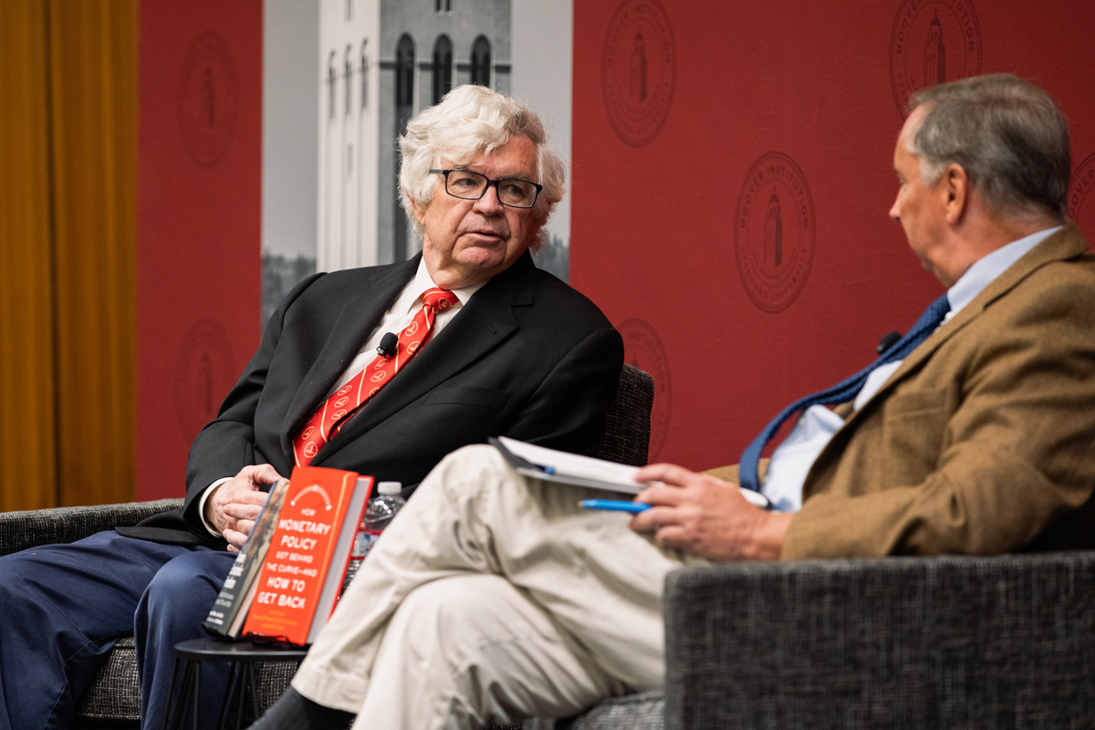 Senior Fellow John B. Taylor is seen speaking to Distinguished Policy Fellow Bill Whalen in Blount Hall on August 11, 2024. (Patrick Beaudouin)