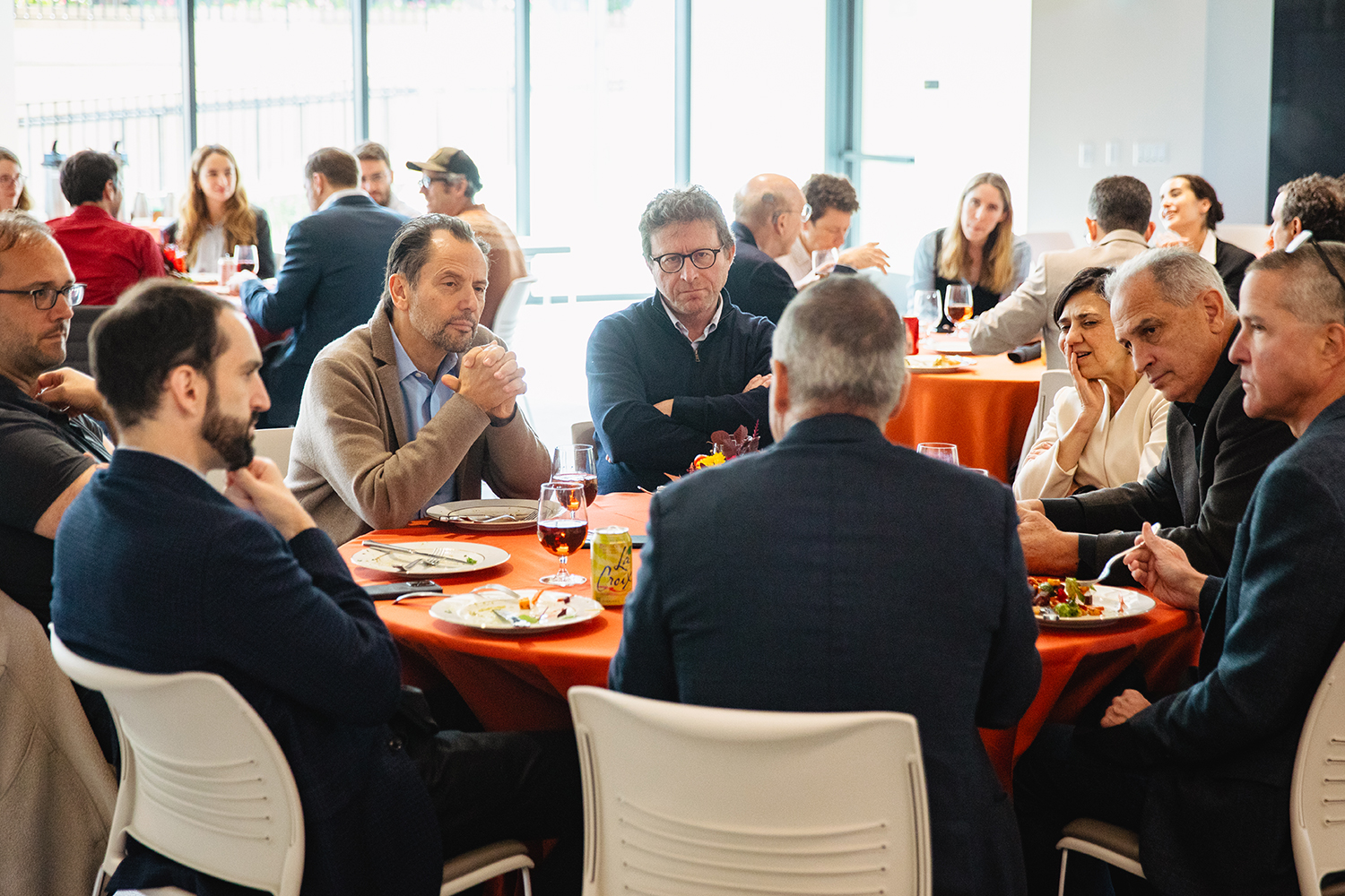 Conference participants discussing the implications of immigration research over lunch.