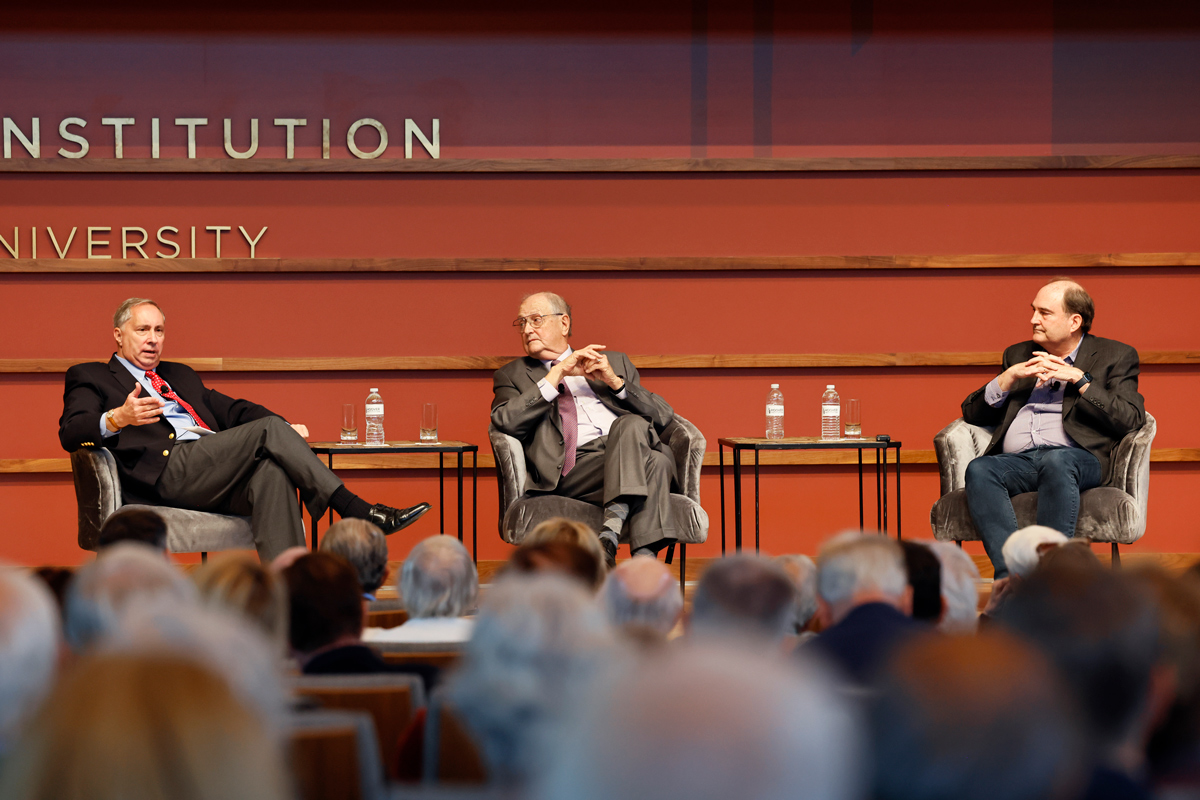 Distinguished Policy Fellow Bill Whalen (left) speaks to senior fellows David Brady (center) and Doug Rivers (right) about their national polling project in Hoover’s Hauck Auditorium on October 17, 2024. (Eric Draper)