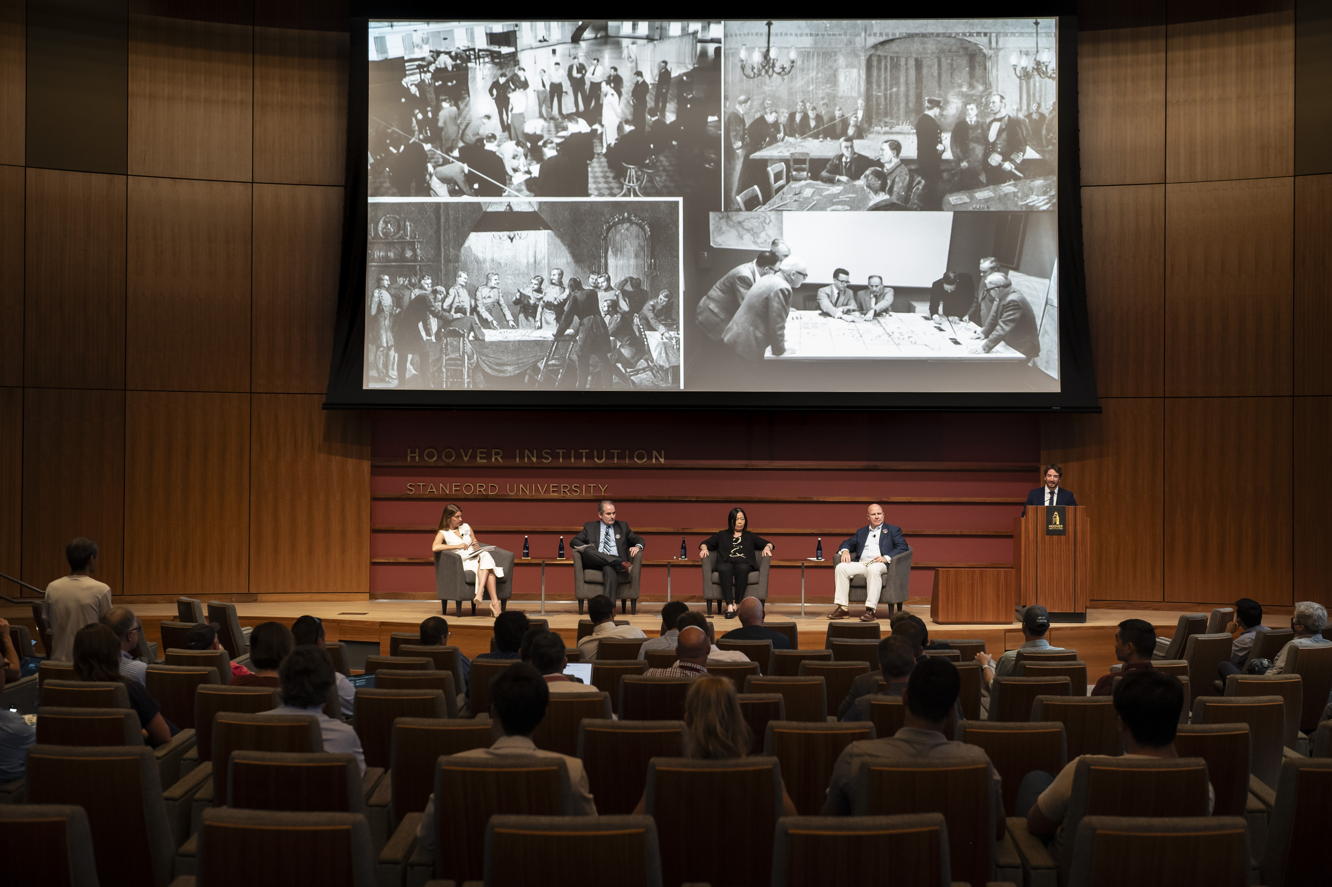 Wargaming and Crisis Simulation Initiative program manager Jacob Ganz (right) introduces panelists and speaks about the history of wargaming in Hauck Auditorium on October 8.