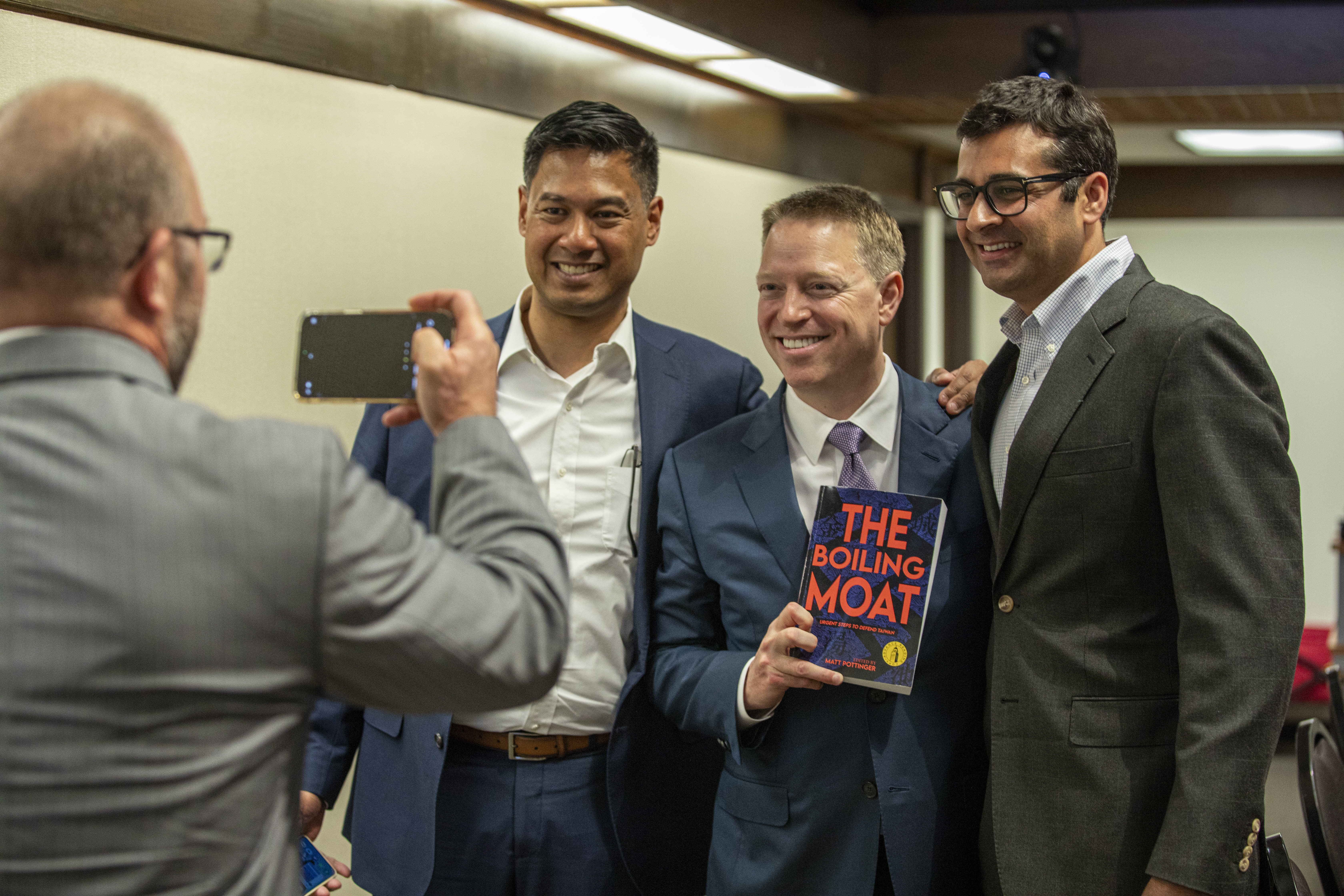 Distinguished Visiting Fellow Matt Pottinger poses with a copy of his book The Boiling Moat and its contributors on May 30, 2024. (Daniel Beck)