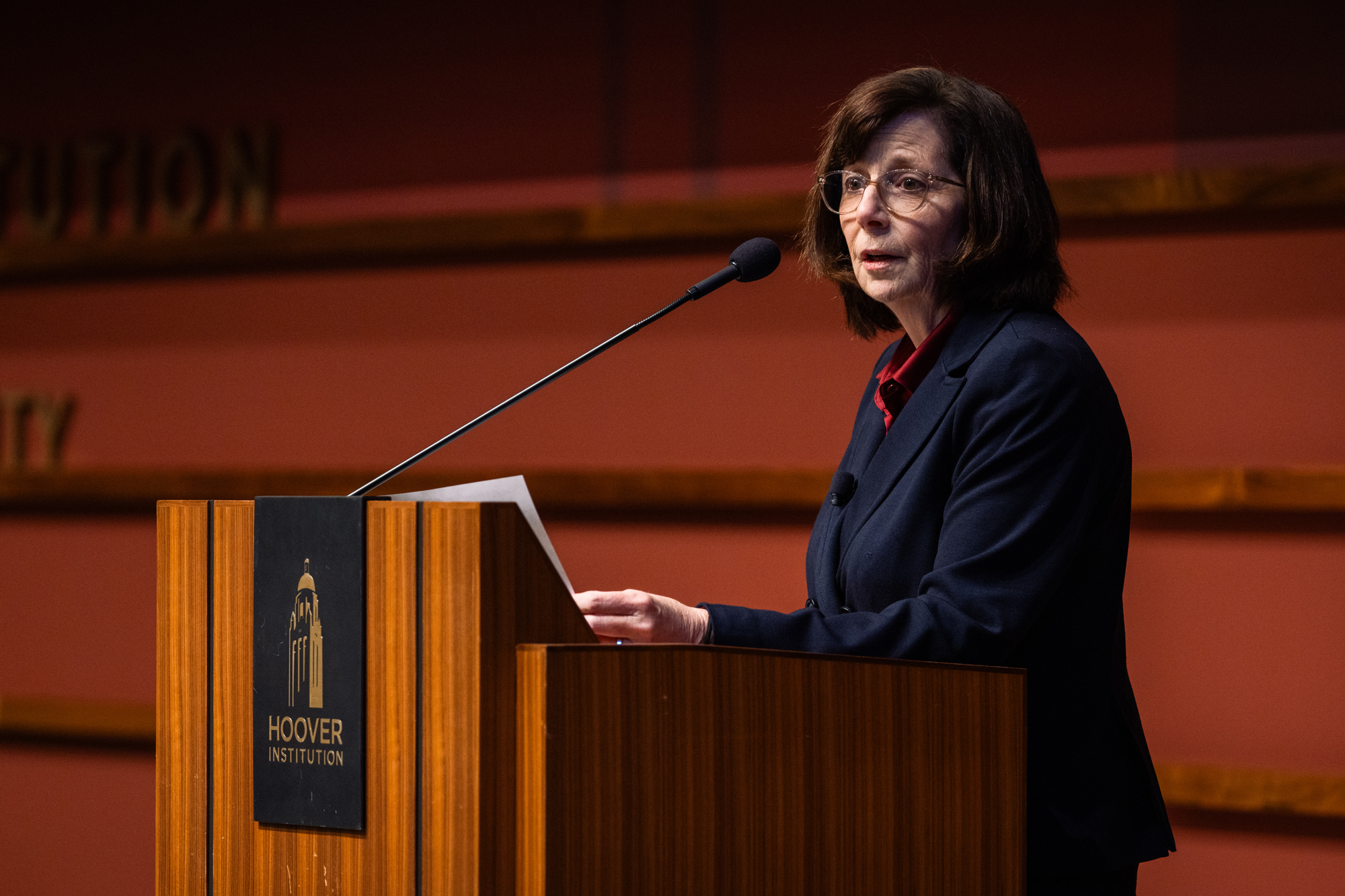 Hoover Distinguished Research Fellow and Hoover Education Summit organizer Margaret (Macke) Raymond speaks in Hauck Auditorium on January 10, 2025. (Patrick Beaudouin)