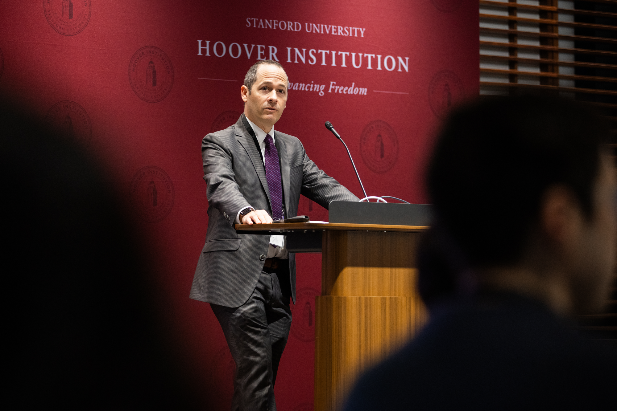 Joshua D. Rauh, Senior Fellow and Director of Hoover’s State and Local Governance Initiative, speaks to attendees of the Conference on Collaborative State and Local Policy Research in Shultz Auditorium on January 27, 2025. (Patrick Beaudouin)