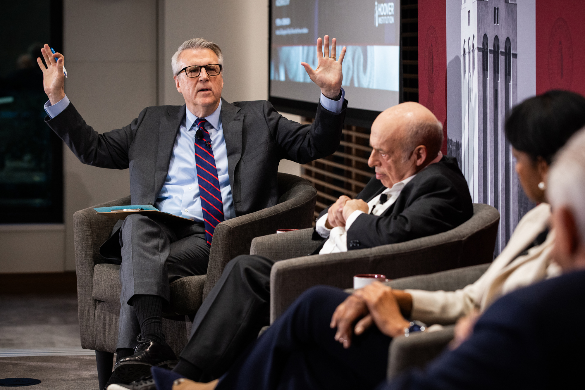 Moderator Peter M. Robinson gestures to the panel at the inaugural George P. Shultz Memorial Lecture on Human Rights on February 12, 2025. (Patrick Beaudouin)