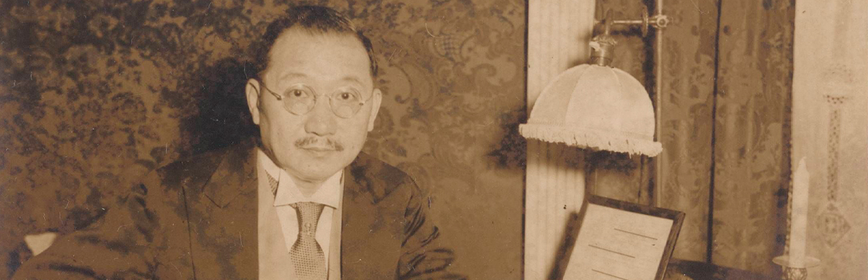 detail of a sepia photograph of H. H. Kung in suite seated at desk