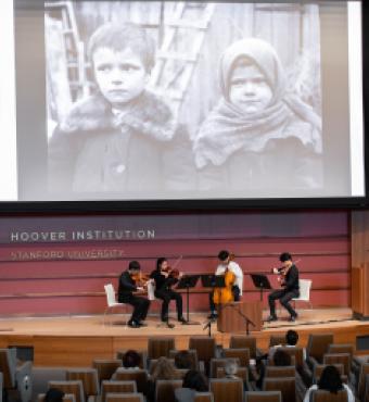 Film on a screen with a string quartet playing below