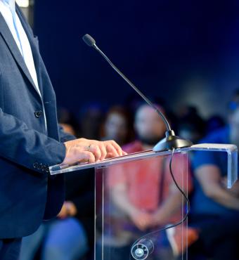 Speaker at podium making a speech