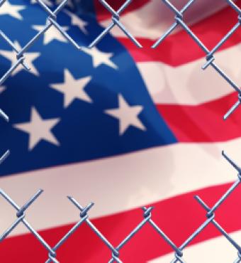 Chainlink fence with an american flag.