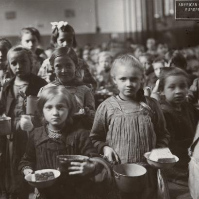 Black and white photograph of children receiving food at an American Relief Administration kitchen in Vienna