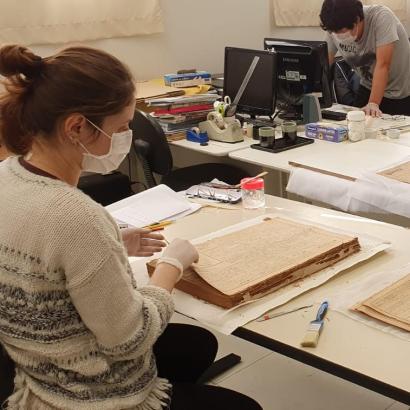 Conservators at Historical Museum of Japanese Immigration working on Burajiru Jiho newspapers