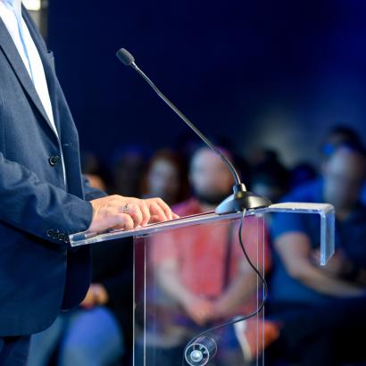 Speaker at podium making a speech