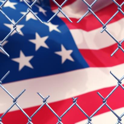 Chainlink fence with an american flag.