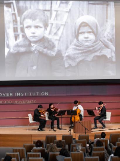 Film on a screen with a string quartet playing below