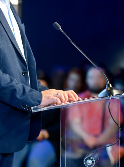 Speaker at podium making a speech