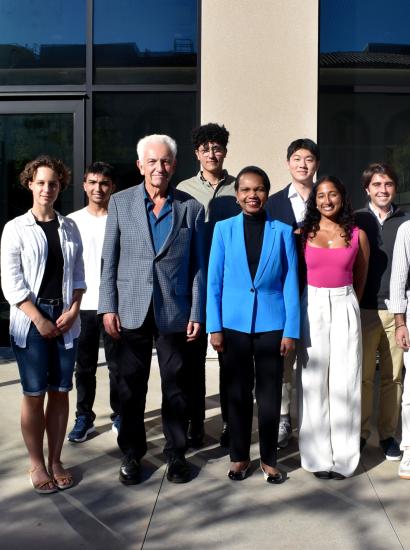 Hoover Institution Director Condoleezza Rice and Senior Fellow Russell A. Berman stand with winners of the Distinguished Undergraduate Essay Competition outside the Shultz Building on October 15, 2024.