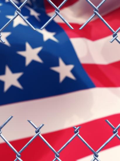 Chainlink fence with an american flag.