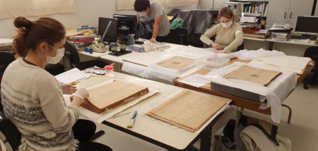 Conservators at Historical Museum of Japanese Immigration working on Burajiru Jiho newspapers