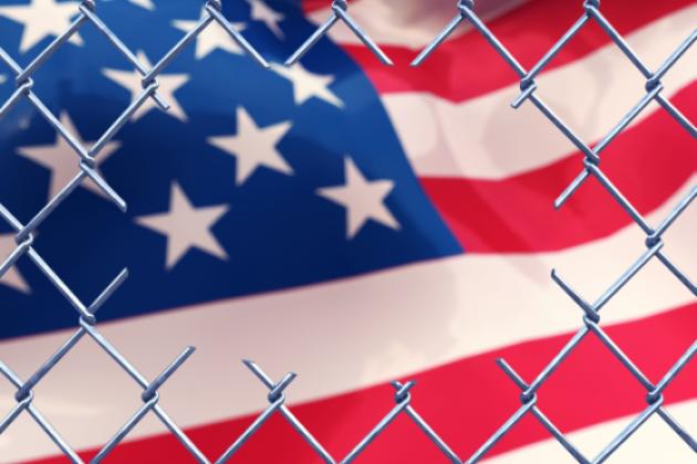 Chainlink fence with an american flag.