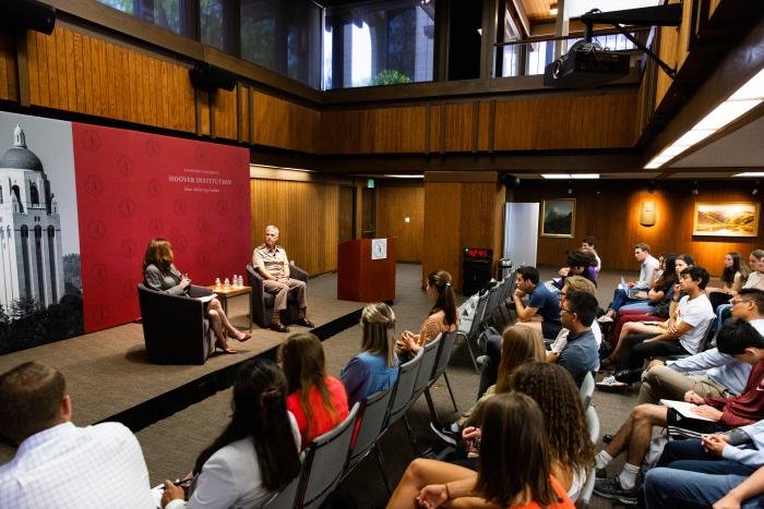 Amy Zegart (left) and General Paul Nakasone in a fireside chat at the Hoover Institution with an audience of Stanford University students.