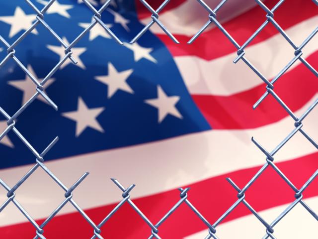 Chainlink fence with an american flag.