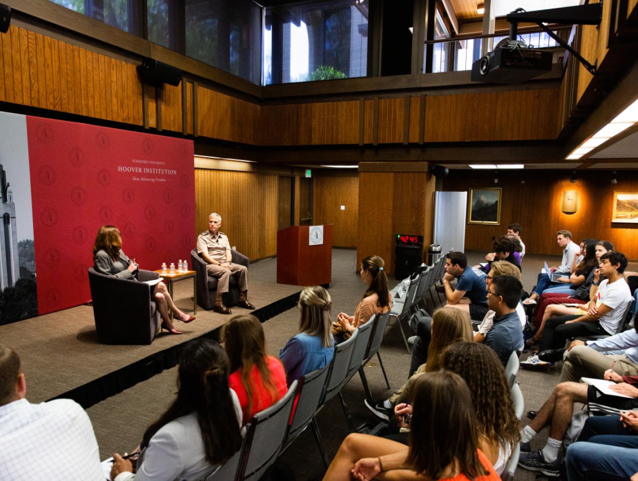 Amy Zegart (left) and General Paul Nakasone in a fireside chat at the Hoover Institution with an audience of Stanford University students.