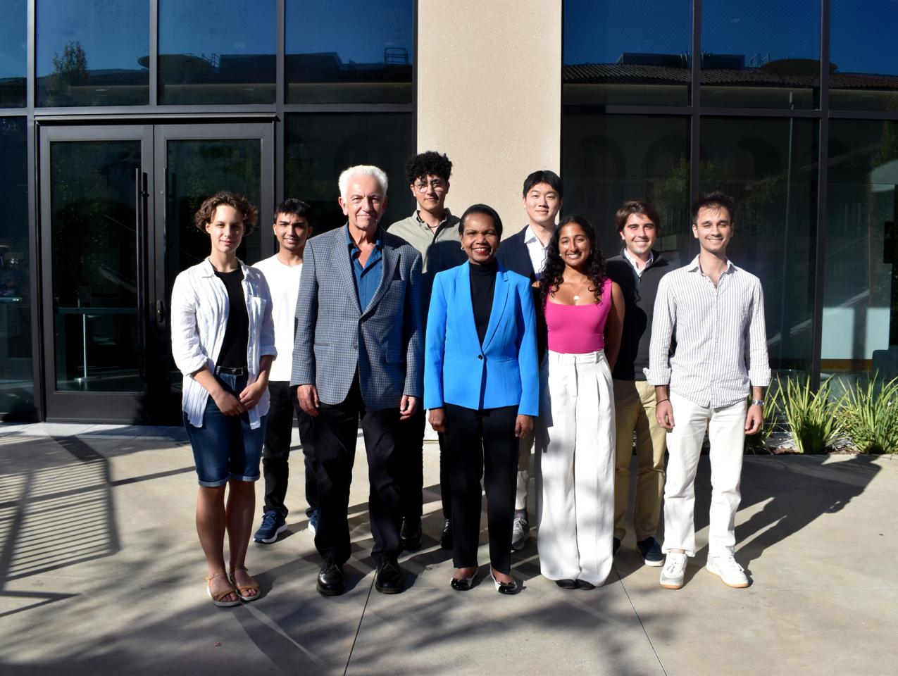 Hoover Institution Director Condoleezza Rice and Senior Fellow Russell A. Berman stand with winners of the Distinguished Undergraduate Essay Competition outside the Shultz Building on October 15, 2024.