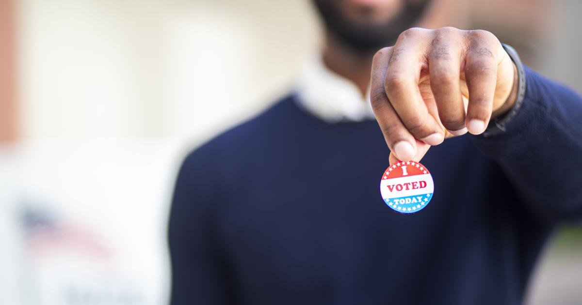 Young Black Man with I voted Sticker stock photo