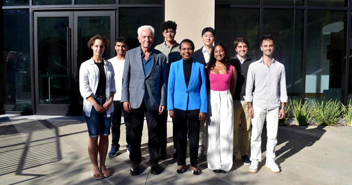 Hoover Institution Director Condoleezza Rice and Senior Fellow Russell A. Berman stand with winners of the Distinguished Undergraduate Essay Competition outside the Shultz Building on October 15, 2024.