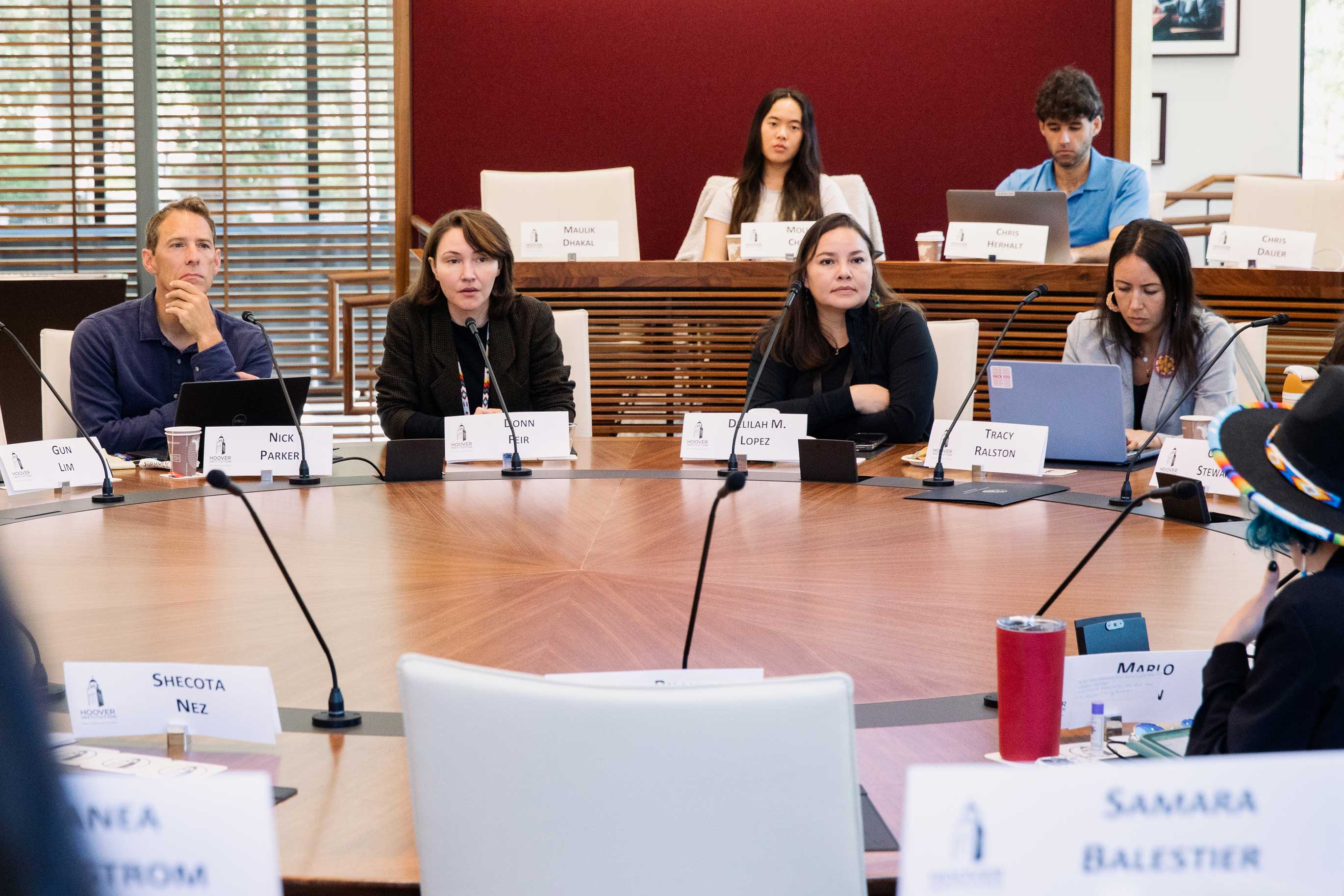 Senior Fellow Dominic Parker (far left) and University of Victoria economica professor Donn Feir (center left) listen to participants in the Hoover Institution Indigenous Student Seminar on August 9, 2024.