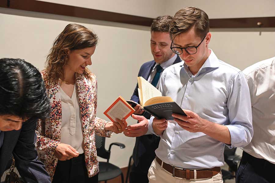 Participants in the Hoover Institution International Seminar review Hoover Library & Archives materials after a presentation by Bertrand Patenaude, instruction and outreach archivist, in June 2024.