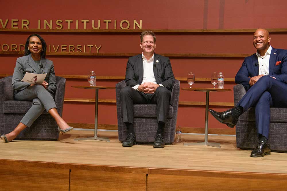 Director Condoleezza Rice speaks with New Hampshire governor Chris Sununu (center) and Maryland governor Wes Moore at the RAI launch on November 30, 2023.